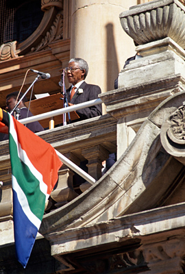 The UN has been involved with the situation in South Africa for more than four decades.  It has spearheaded the international campaign against apartheid and initiated and supported programmes aimed at alleviating the suffering of its victims. It has also provided a forum for the representatives of South African organizations such as the African National Congress to advance the anti-apartheid campaign. South Africa held its first all-race elections from April 26 to April 29, 1994. Newly-elected President Nelson Mandela delivering his inaugural address  from a balcony of the Townhall.