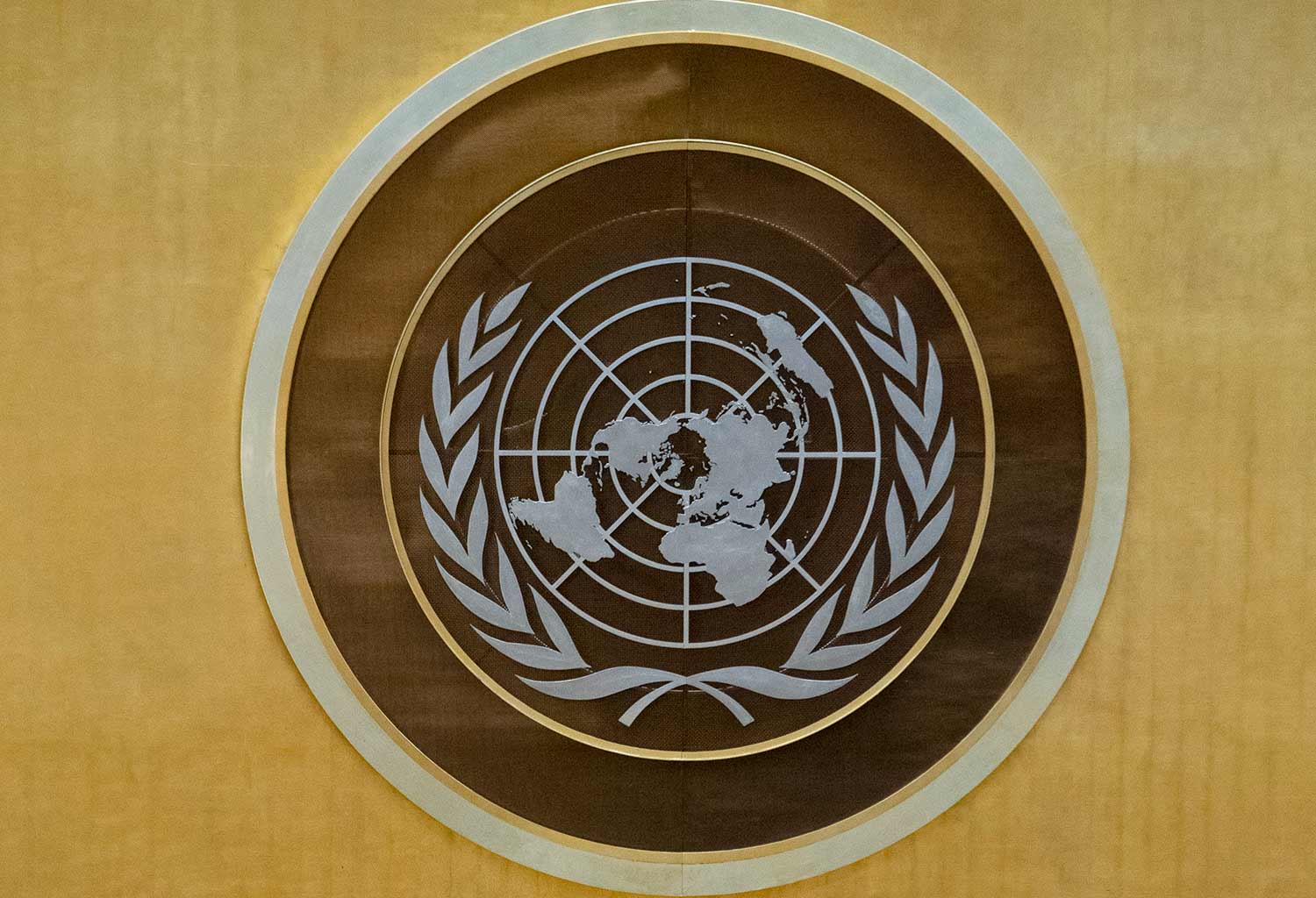 Close up view of the UN emblem in gold at the General Assembly hall.
