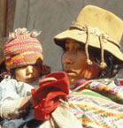 An indigenous woman holding her baby