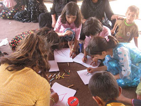 Iraqi children drawing with crayons