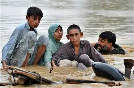 people wading through water in Pakistan floods