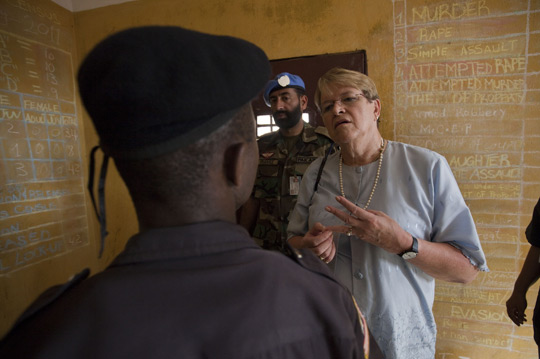 The Special Representative of he Secretary-General for Liberia, Ellen Margrethe Loej, talks with a Liberian corrections officer while visiting a detention facility, 2011.  UN Photo/ Staton Winter