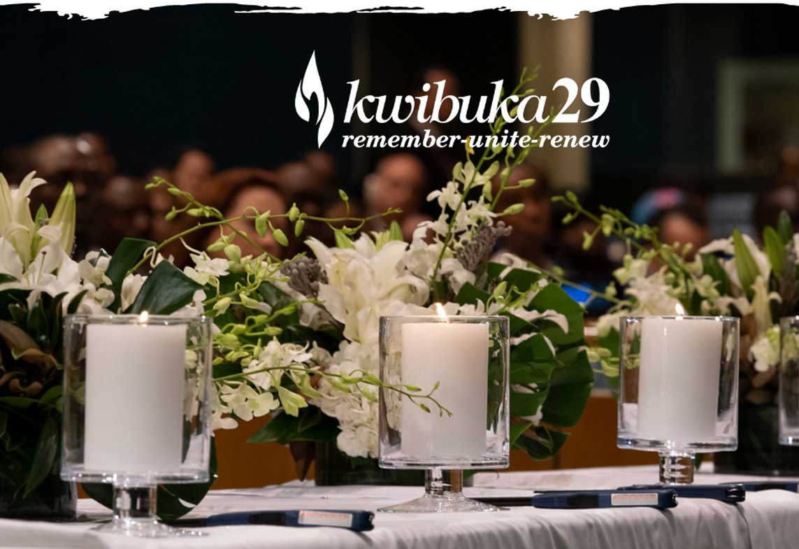 Kwibuka29 sign with candles and flowers on table