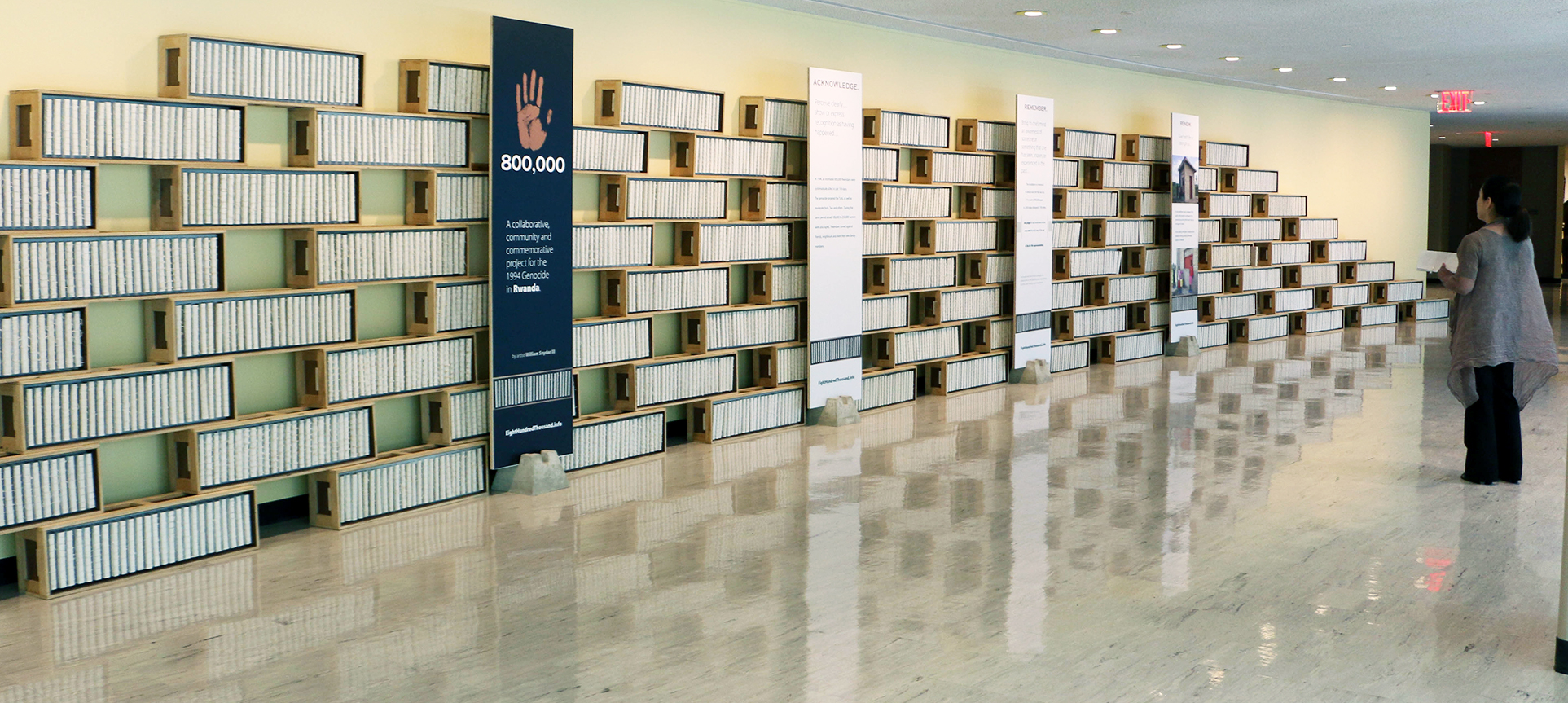 Woman looks at the '800,000: Acknowledge, Remember, Renew' exhibit at UNHQ