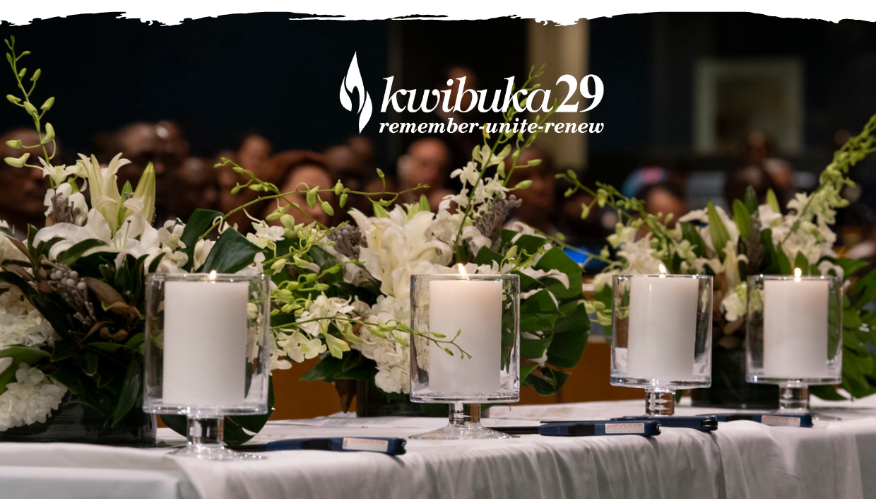 Kwibuka29 sign with candles and flowers on table