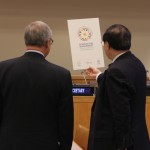 DESA officials display a post of the conference logo