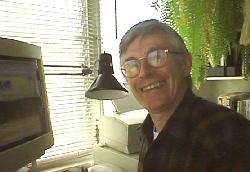 Image of John Mathiason Sitting at His Computer