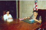 Ms Saras Jagwanth, Technical advisor of the Division for the Advancement of women, with President Ellen Johnson-Sirleaf reading a copy of the Convention