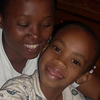 Gisimba’s wife holds their little daughter.