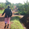 A detainee walks alongside a road.