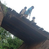 Children walk over a bridge. Jean-Marie photographed several bridges because it reminded him of how innocent people were thrown into the Nyabarongo River during the genocide. Annociata’s father was killed this way.