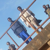People stand on top of a bridge.
