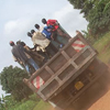 Men ride on a truck.