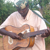 A man sings in front of children.