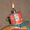 A photograph of a paraffin lamp burning in Thacien’s home. Many people do not have electricity in Rwanda and they must use alternatives such as these lamps for light.