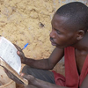 Thacien reads and studies from the bible.
