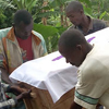 A group of men carry the casket of a young woman who died from malaria.
