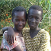 A portrait of two young girls hugging each other.